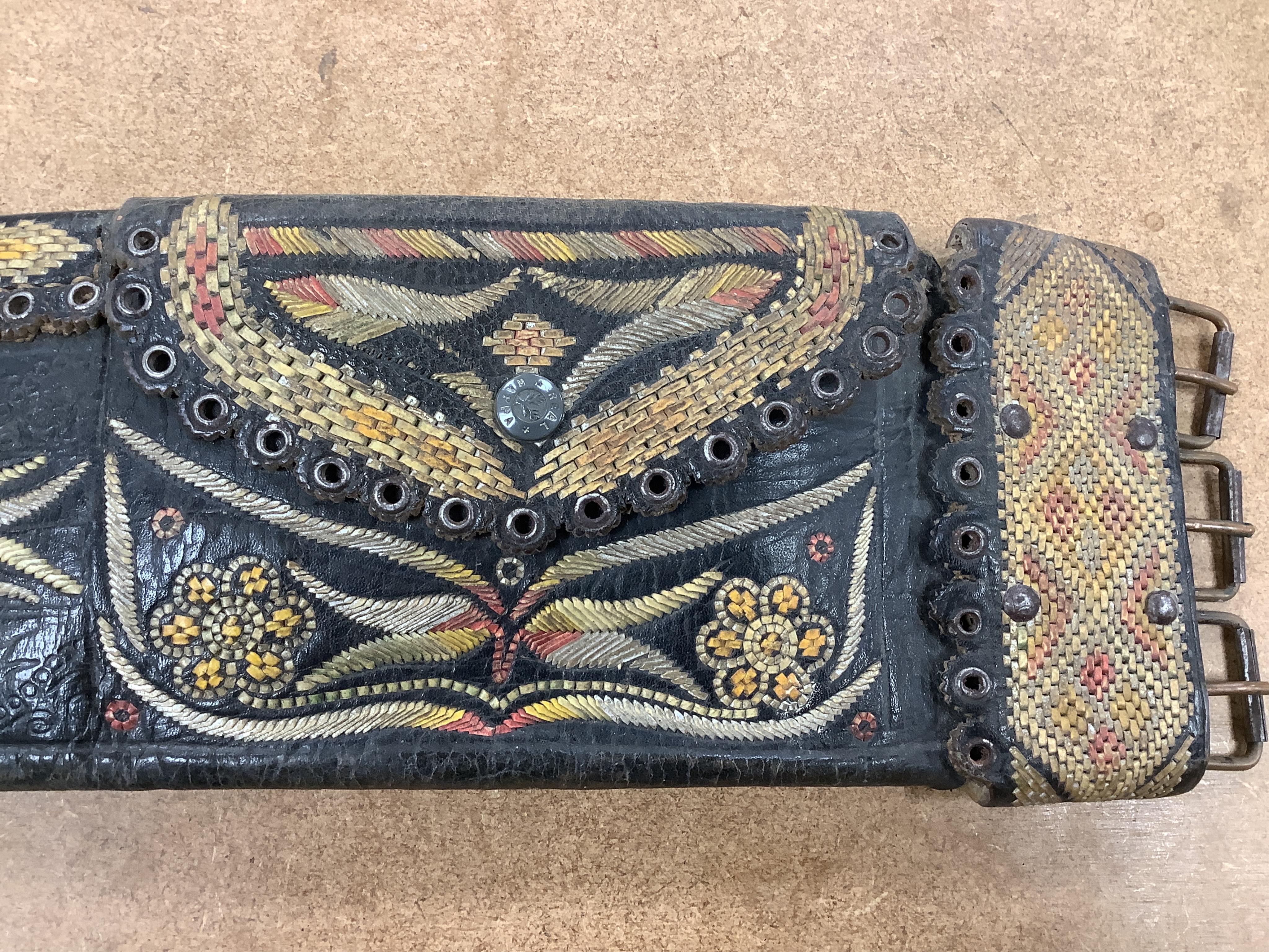 An Argentinian braided leather belt and whips, one with mother of pearl inlay